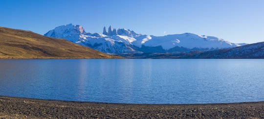 blue lake near brown and white mountains under blue sky during daytime in Nationalpark Torres del Paine Chile
