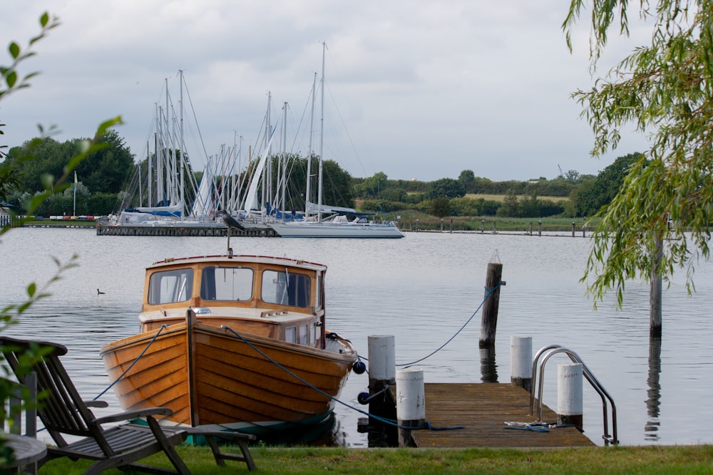 brown and white boat on dock during daytime