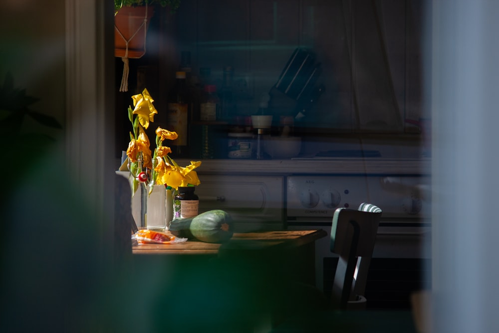 yellow flower on brown wooden table