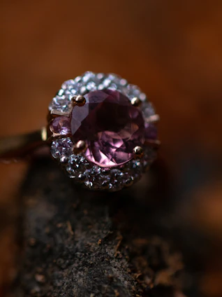 Close-up of a sparkling natural gemstone set in a delicate sterling silver ring, with the Swat mountains softly blurred in the background.