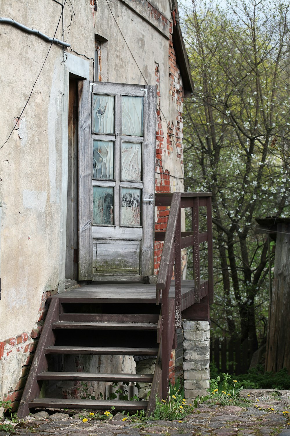 brown wooden staircase near white wooden framed glass window