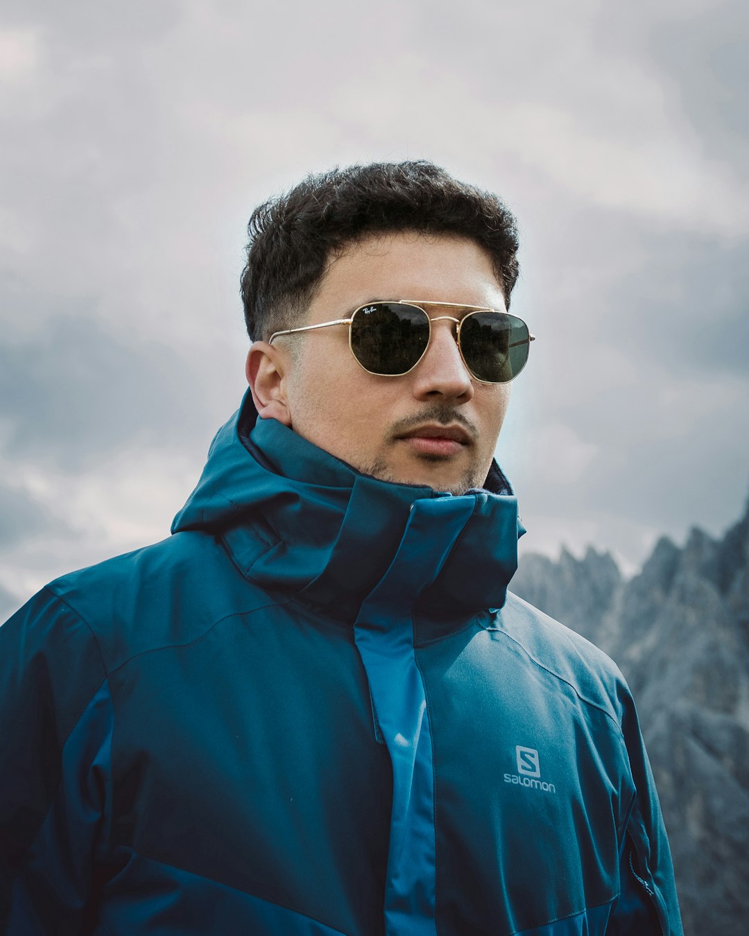 man in blue hoodie wearing black sunglasses