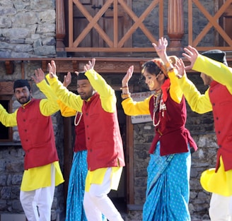 group of people in yellow long sleeve shirt raising their hands