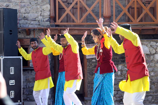 group of people in yellow long sleeve shirt raising their hands