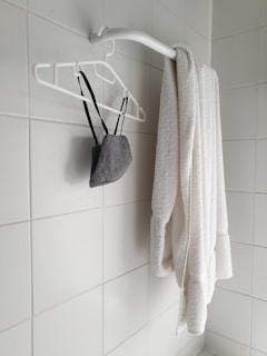 white towel on black plastic hanger