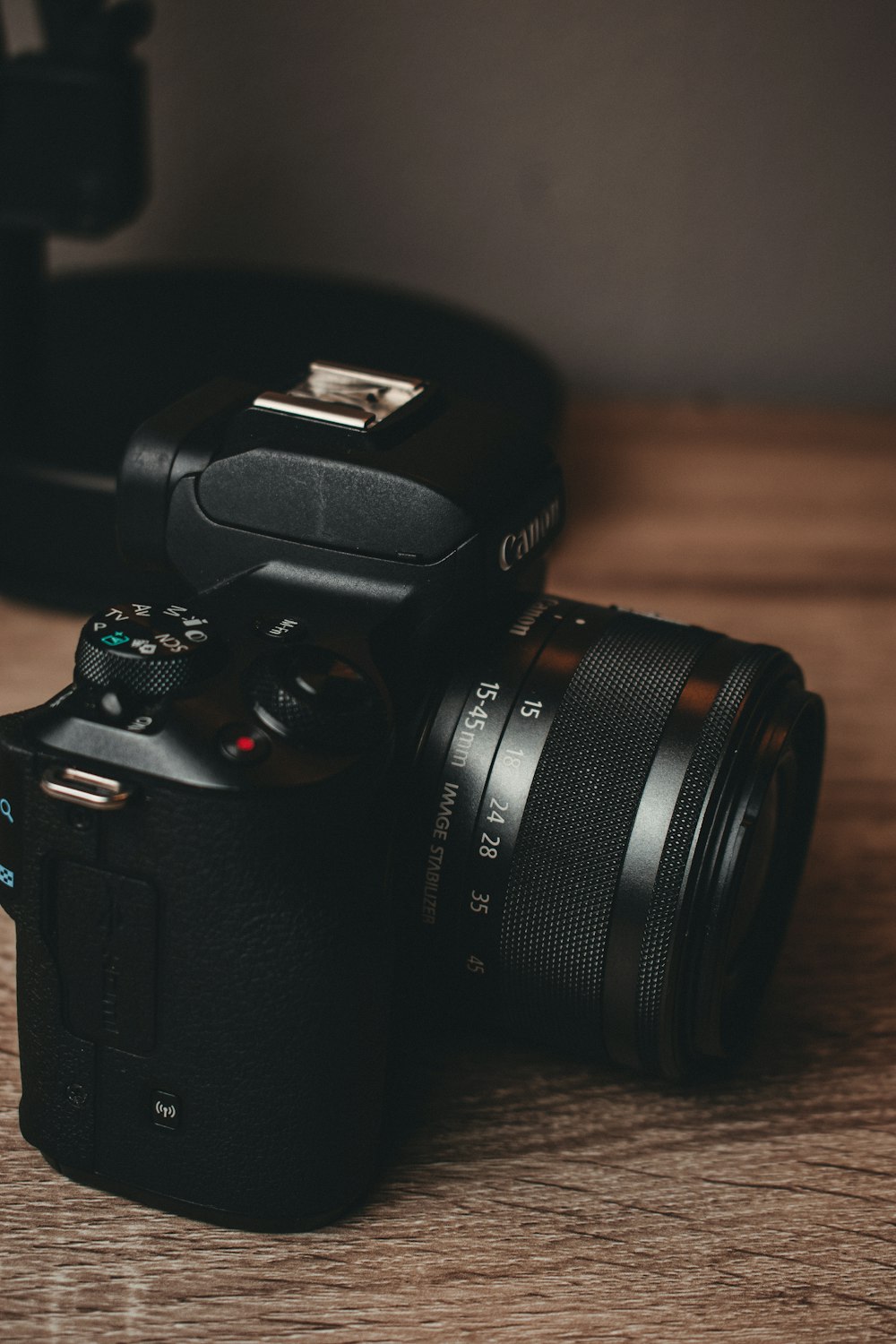 black nikon dslr camera on brown wooden table