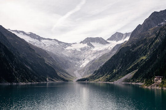 lake near mountains under white sky during daytime in Wasserkraftwerke im Zillertal Austria