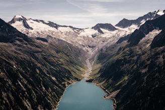 A breathtaking view of Patagonia's rugged mountains and turquoise lakes under a clear sky.