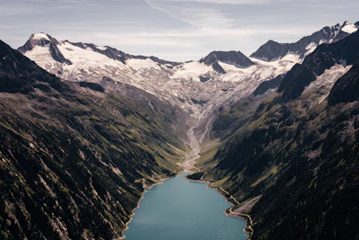 A breathtaking view of Patagonia's rugged mountains and turquoise lakes under a clear sky.