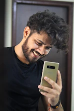 A tradesperson checking their phone and smiling at a new appointment email.