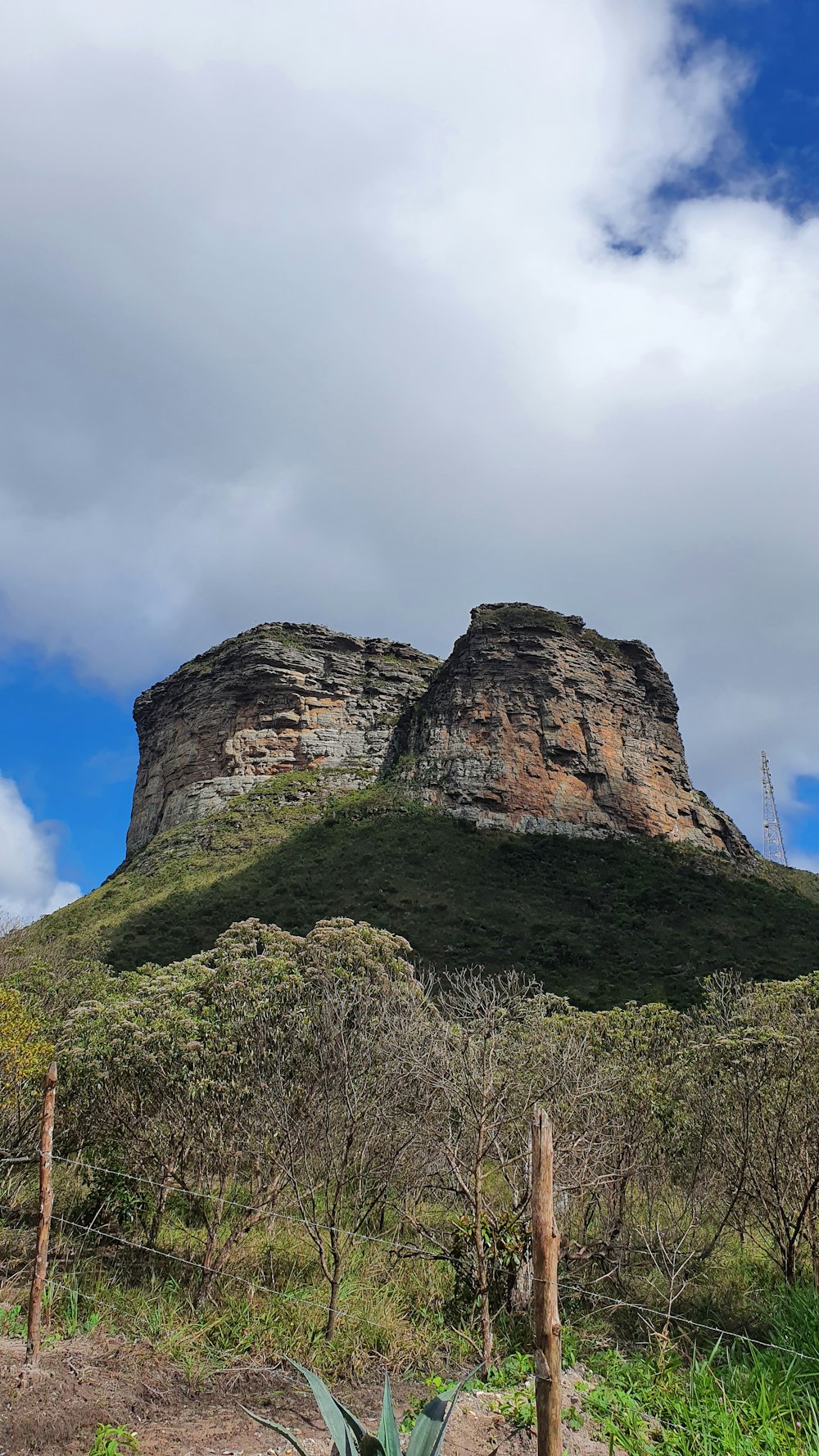 green and brown rock formation under white clouds during daytime