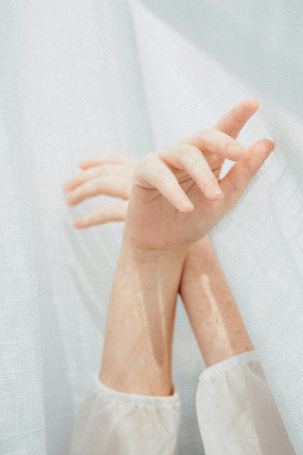 persons feet on white textile