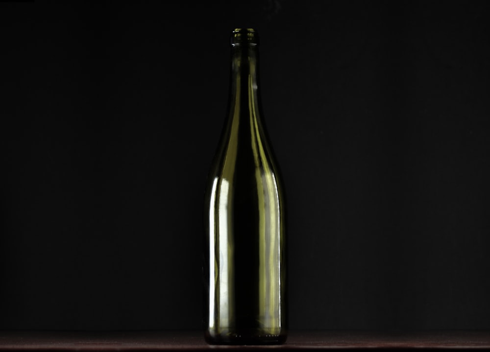 clear glass bottle with black background