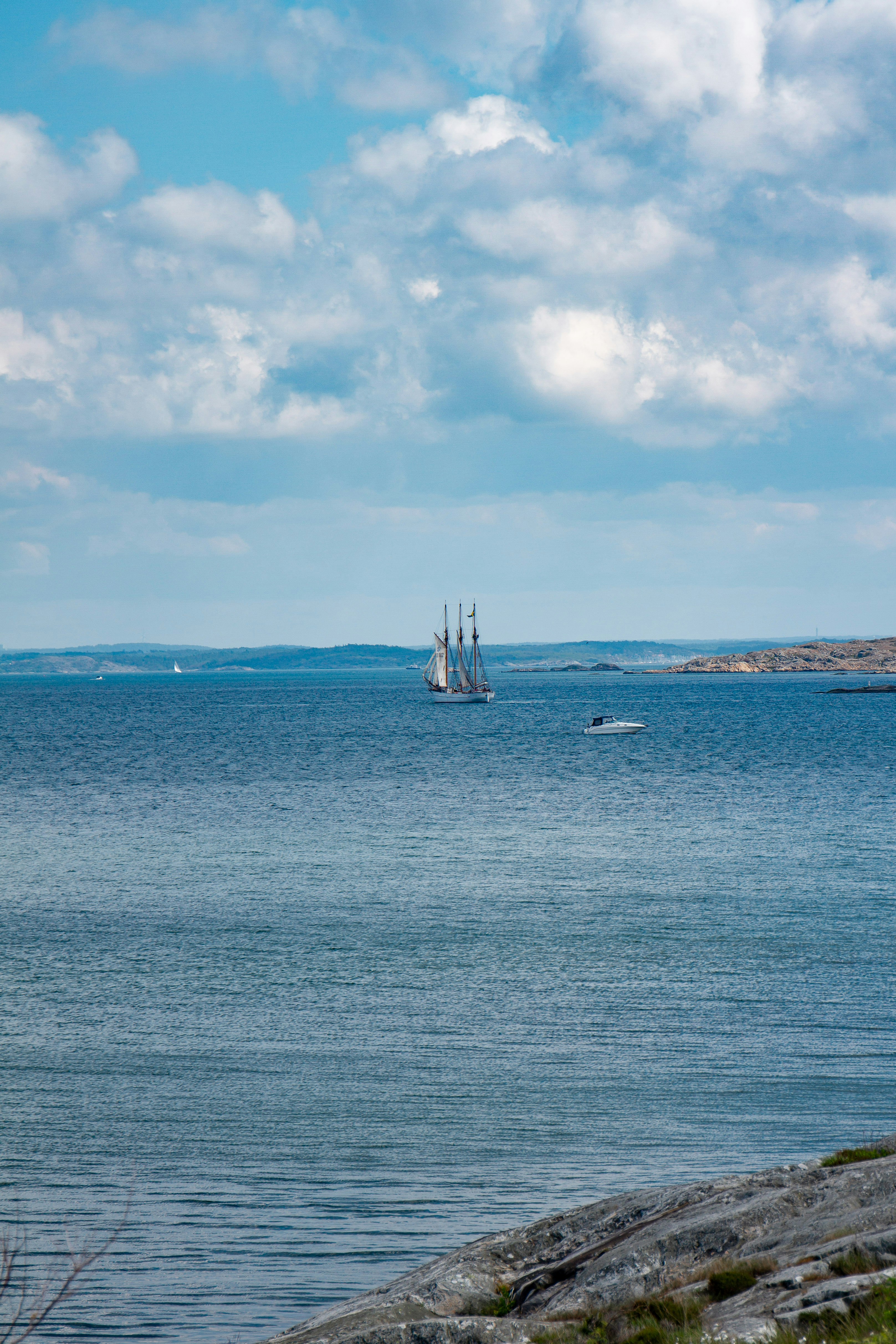 white sail boat on sea under blue sky during daytime