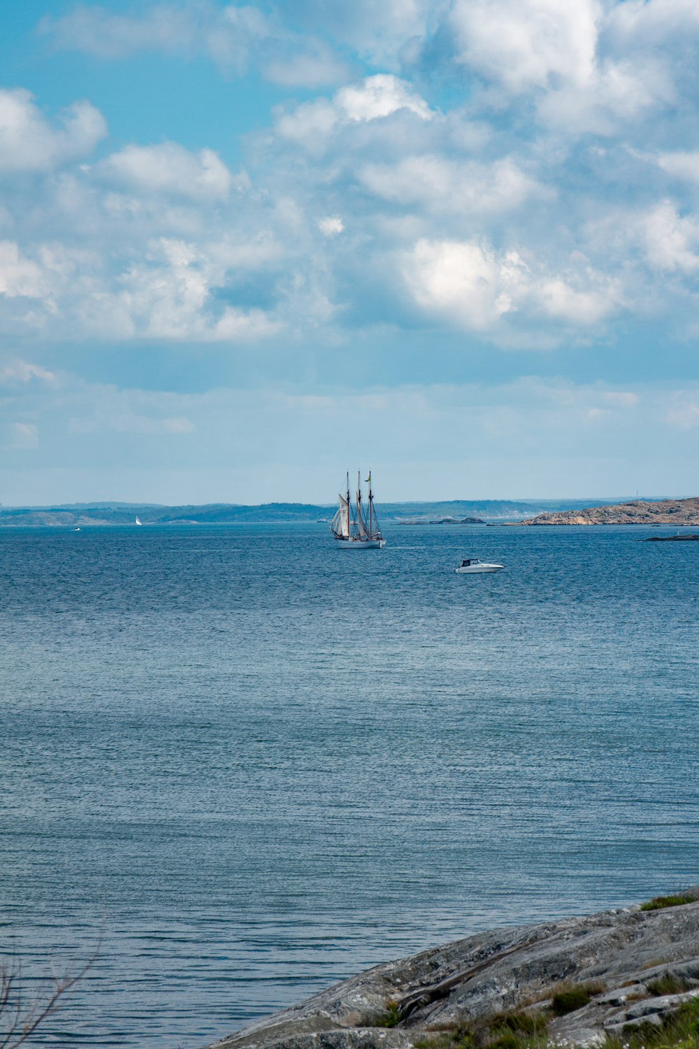 white sail boat on sea under blue sky during daytime