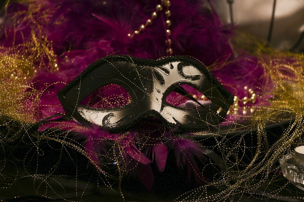 purple and black mask on red textile