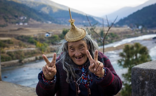 woman in black long sleeve shirt with brown straw hat in Punakha Bhutan