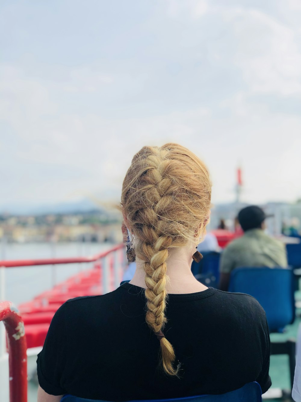 woman in black shirt with brown braided hair