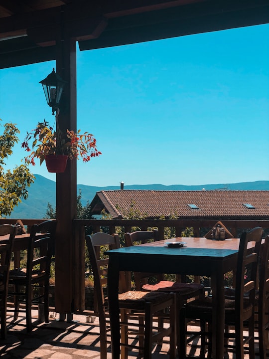 brown wooden table with chairs in Serres Greece