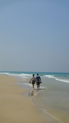 Couple enjoying a peaceful stroll along the sandy shore