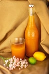 orange juice in clear glass bottle