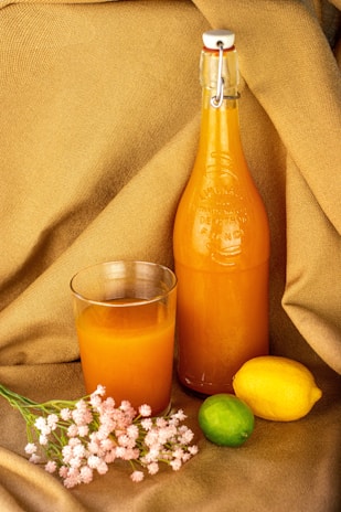 orange juice in clear glass bottle