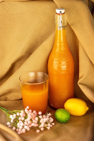 orange juice in clear glass bottle