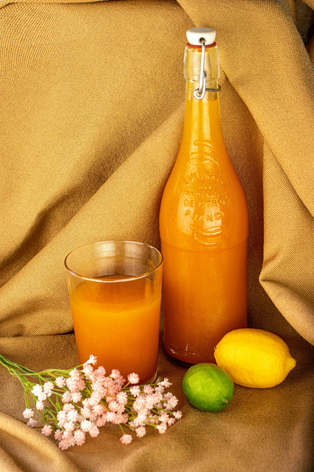 orange juice in clear glass bottle