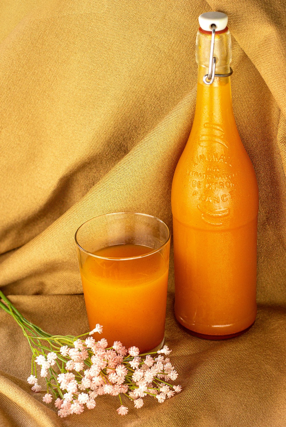 orange liquid in clear drinking glass