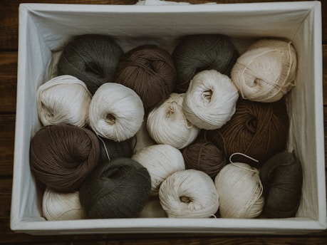 brown and white yarn rolls