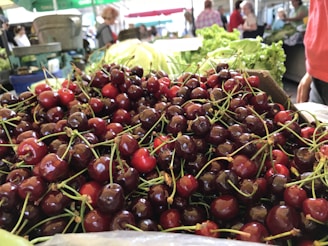 A vibrant display of fresh cherries in rustic wooden crates at Cherry Market Fresno LLC.