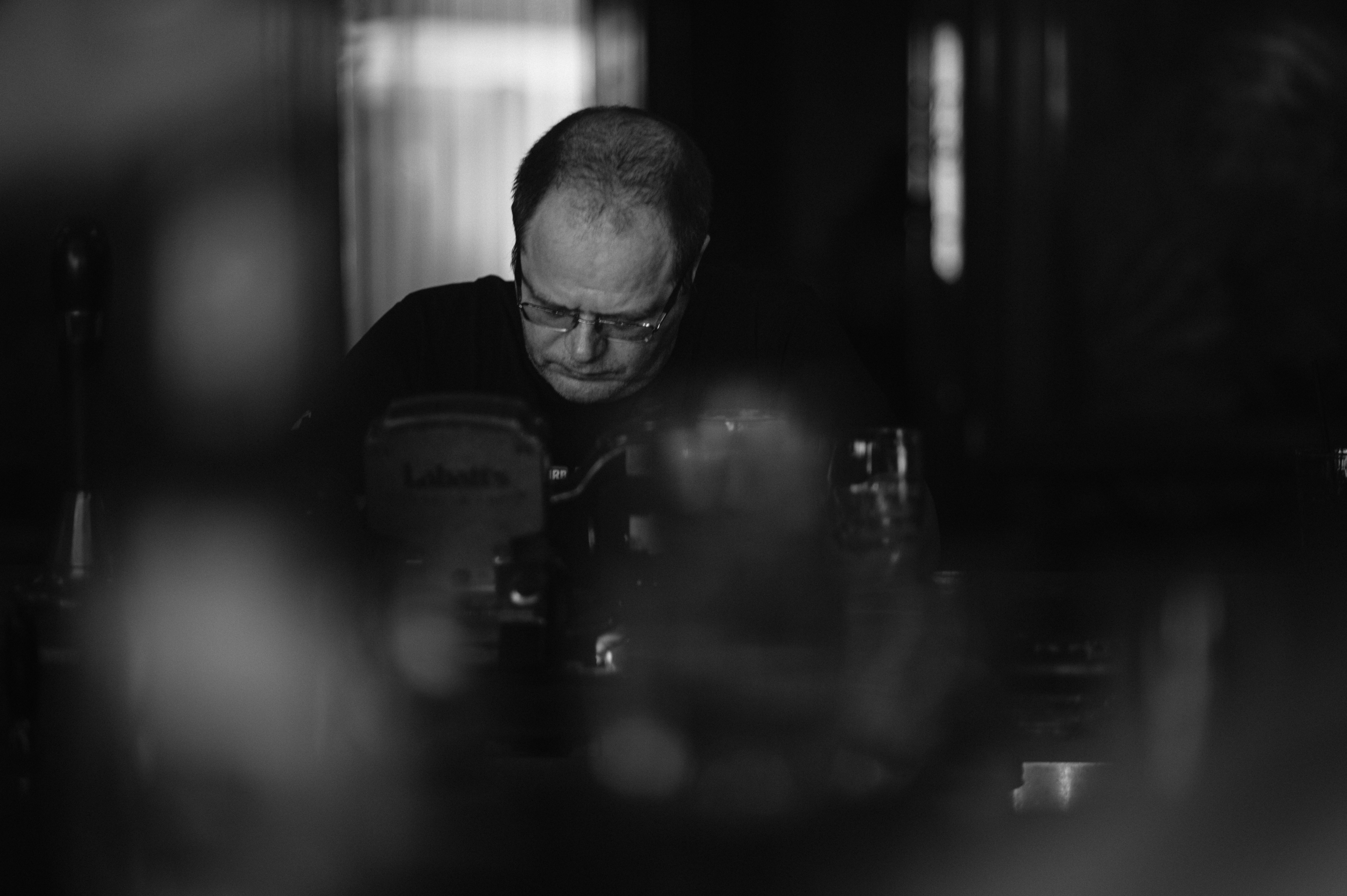 Photo of a man in his 40s, wearing glasses, sitting in a cozy home office
