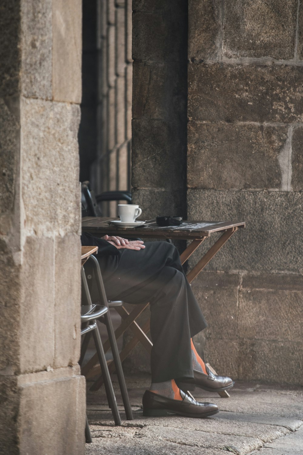 black and gray folding table beside brown concrete wall