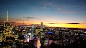 A vibrant city skyline at dusk, symbolizing the entertainment industry.