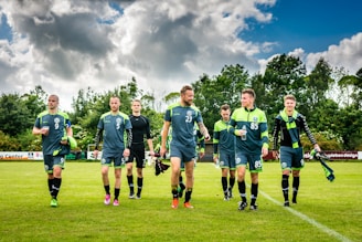 group of men in green soccer jersey shirt on green grass field