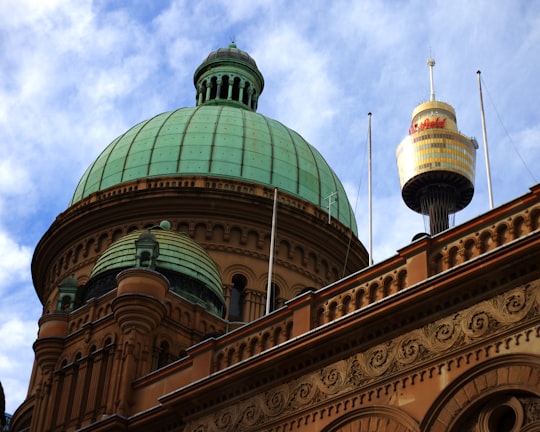 green and brown dome building under white clouds during daytime in Queen Victoria Building Australia