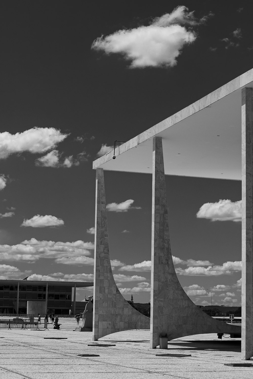 grayscale photo of concrete building under cloudy sky