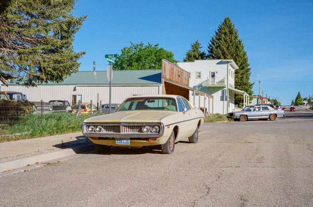 white classic car parked near white building during daytime