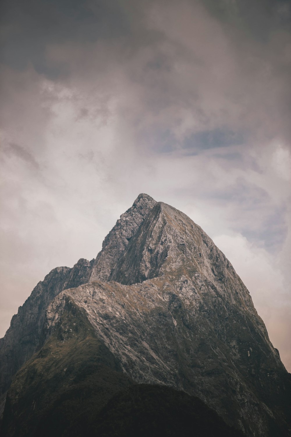 gray rocky mountain under cloudy sky during daytime