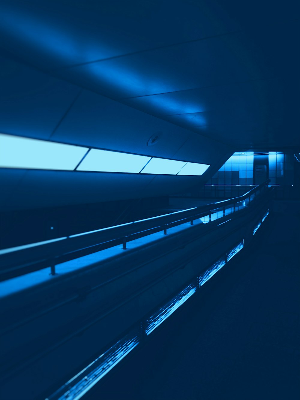 black escalator in a tunnel