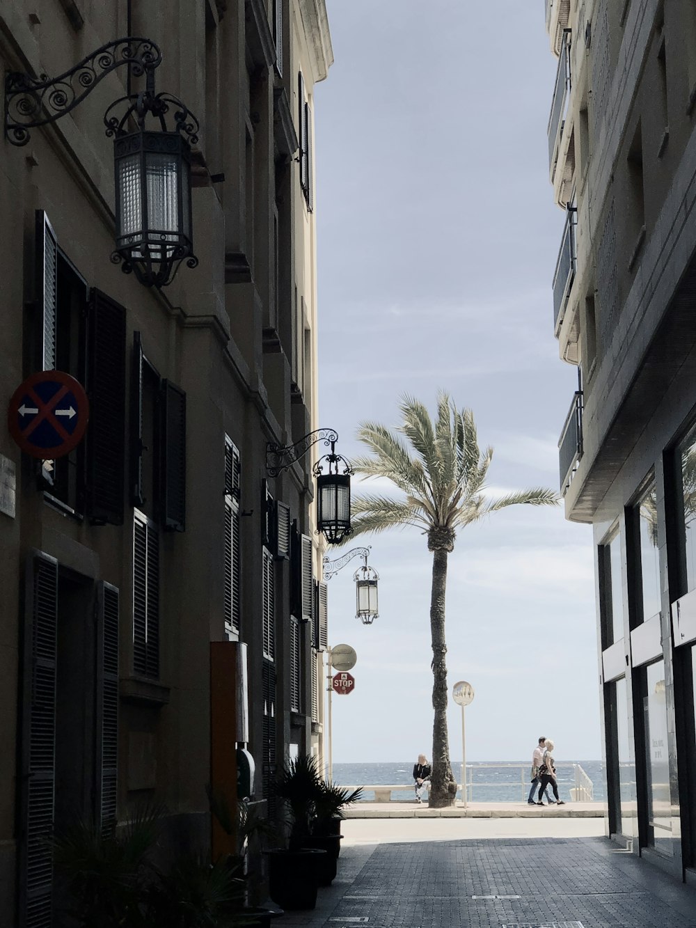 people walking on street between buildings during daytime