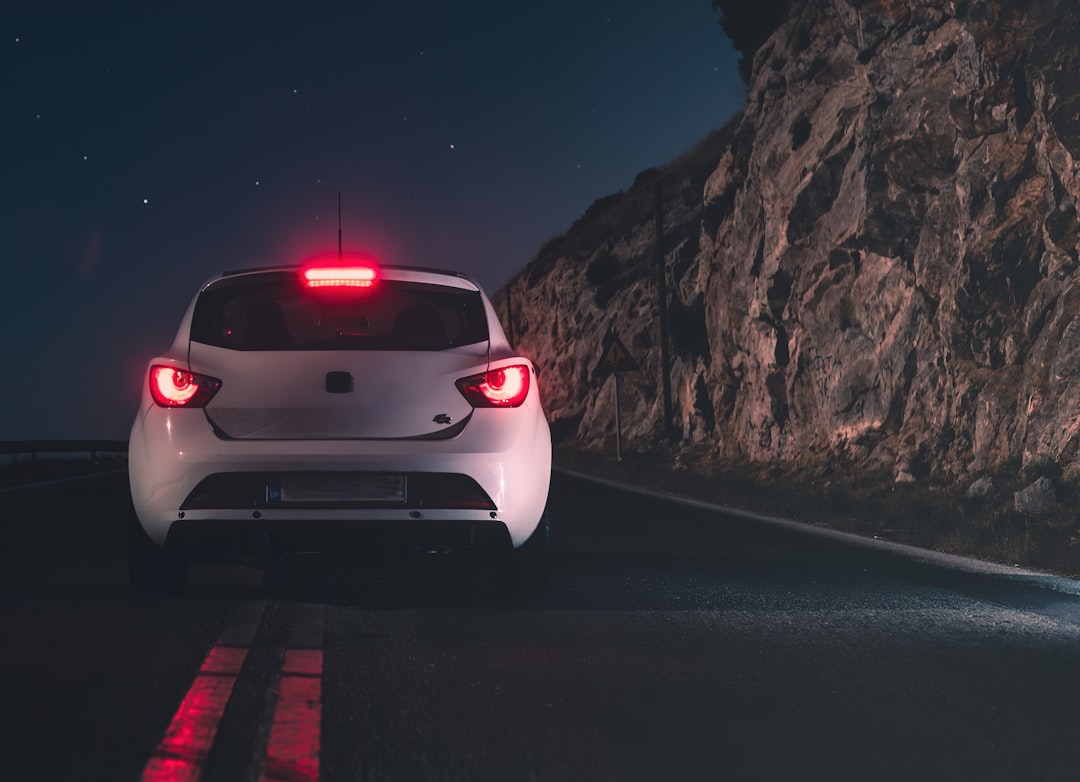 white car on road during night time