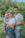 man in blue crew neck t-shirt carrying girl in white and blue stripe dress