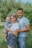 man in blue crew neck t-shirt carrying girl in white and blue stripe dress