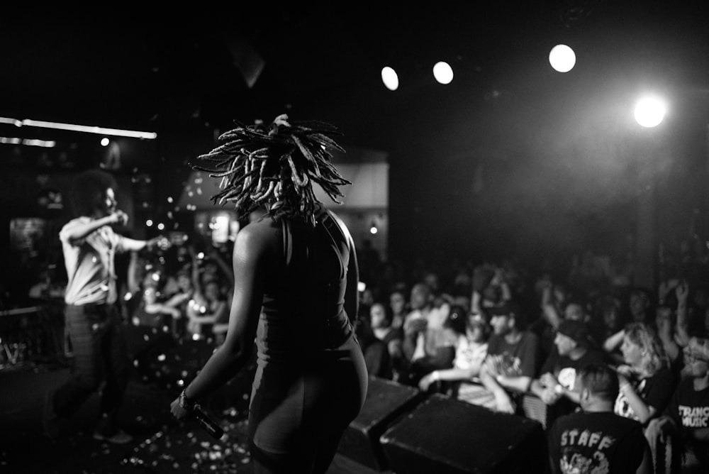 a person standing on a stage in front of a crowd