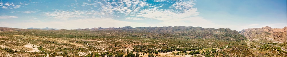 green trees and mountains under blue sky during daytime