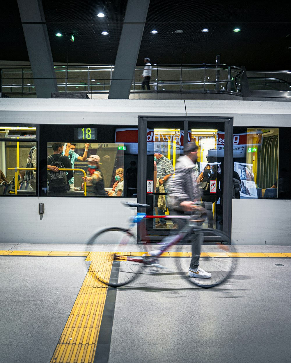 man in black jacket riding bicycle on road during daytime