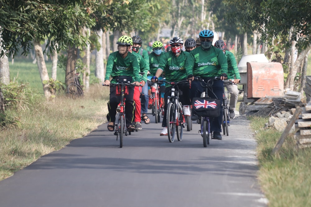 people riding bicycles on road during daytime