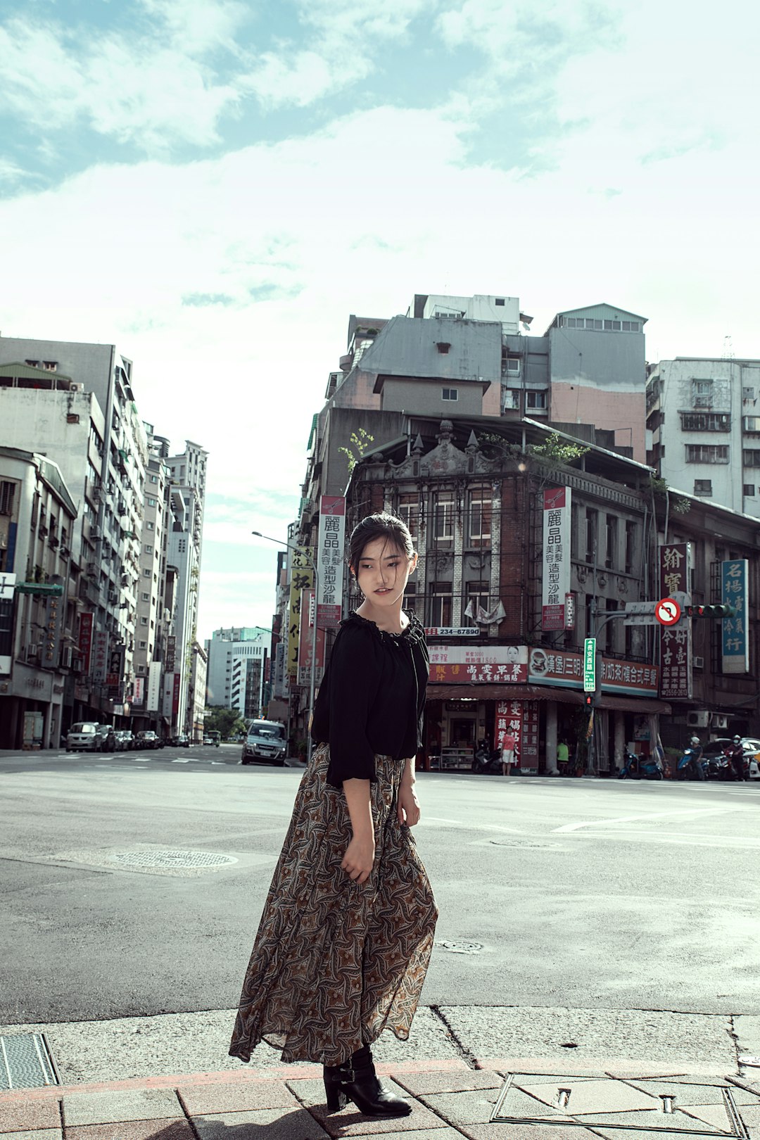 woman in black long sleeve shirt and brown skirt standing on white snow covered ground