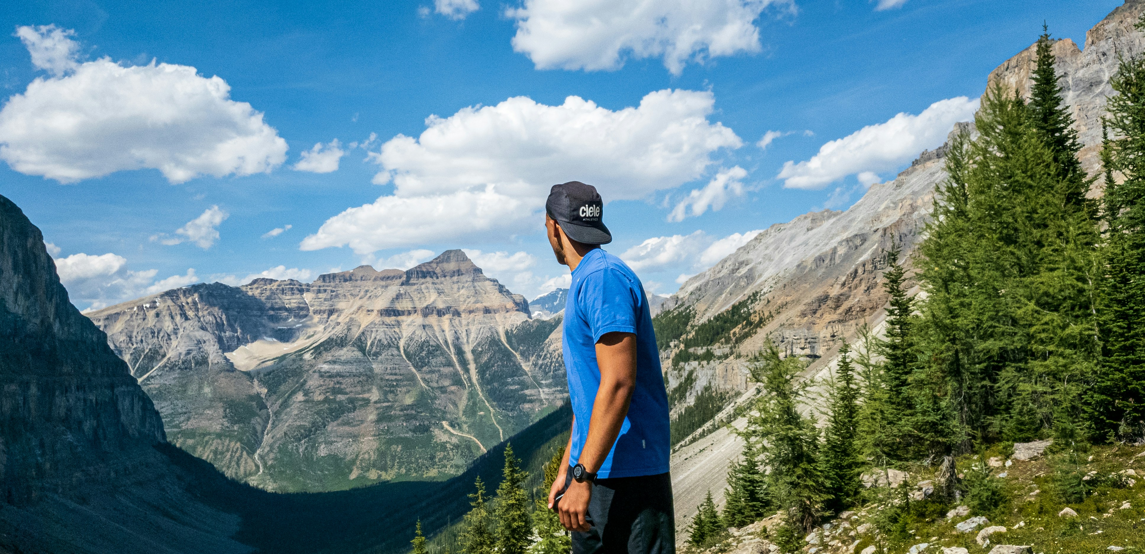 man in blue polo shirt and black pants standing on green grass field during daytime